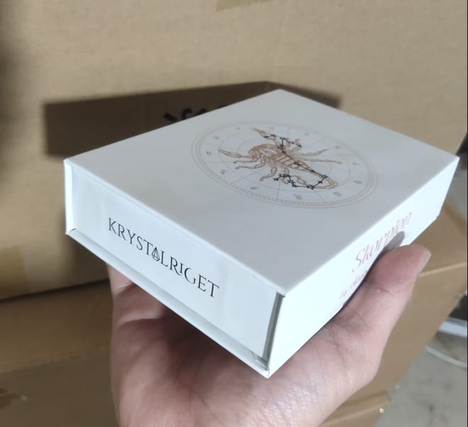 Person holder en Stjernetegnsæske til stjernetegnet Vægten med et astrologisk diagram.