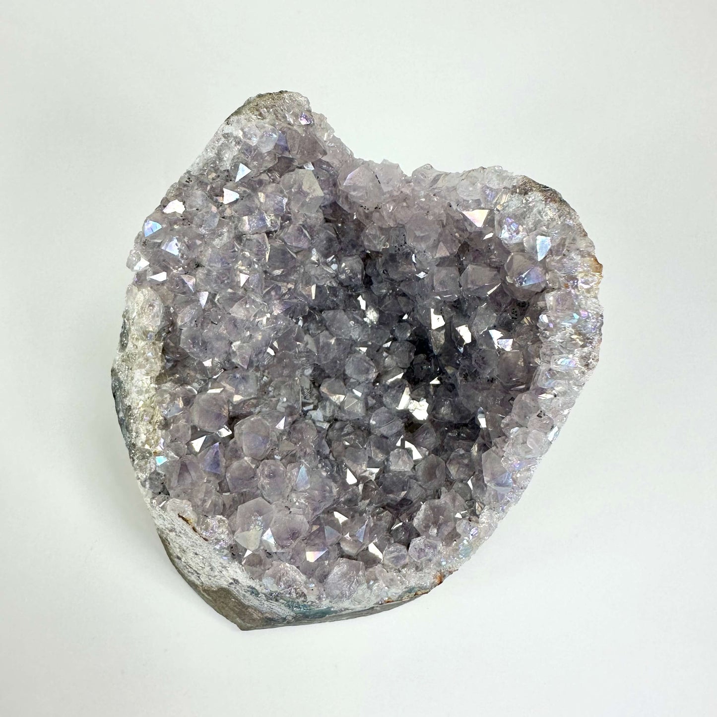 Ametyst aura geode med skinnende lilla krystaller og en rå, ujævn kant.