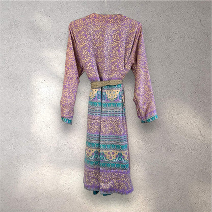 Lilla og gul mønstret kimono hængt på en hvid væg.